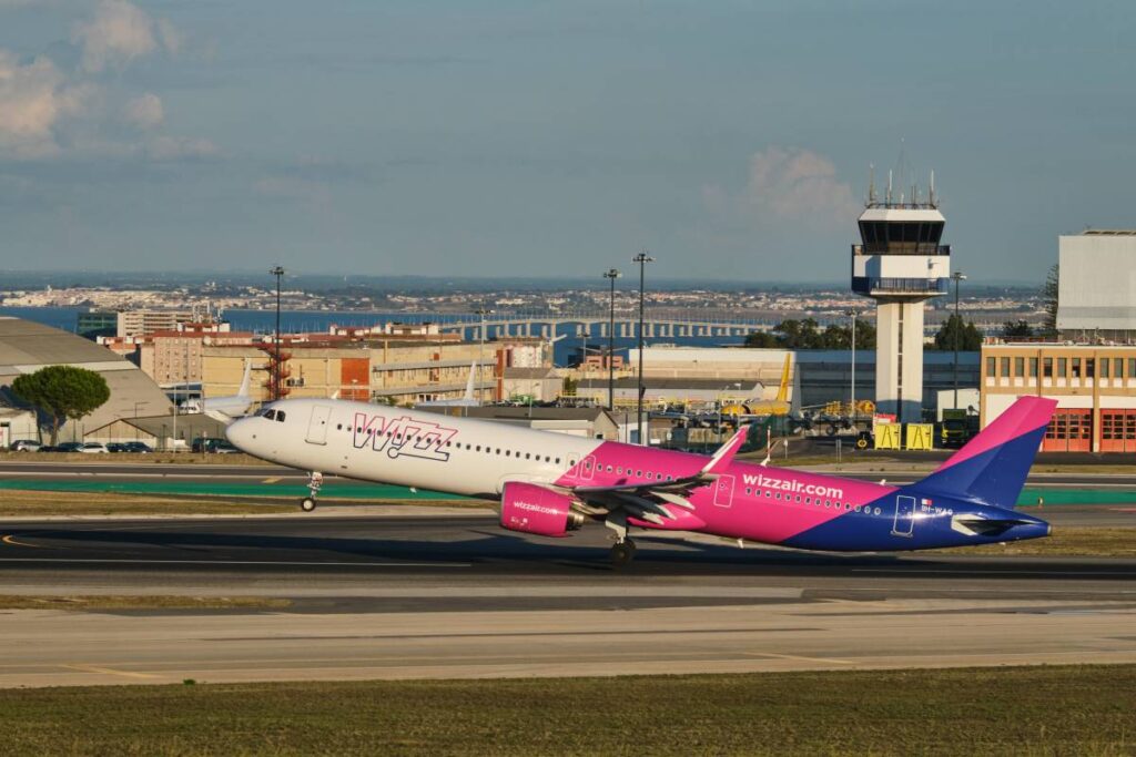 Imagem de um avião da Wizz Air decolando, simbolizando a saída definitiva de Portugal, um passo importante para quem decide emigrar ou mudar-se permanentemente para outro país.
